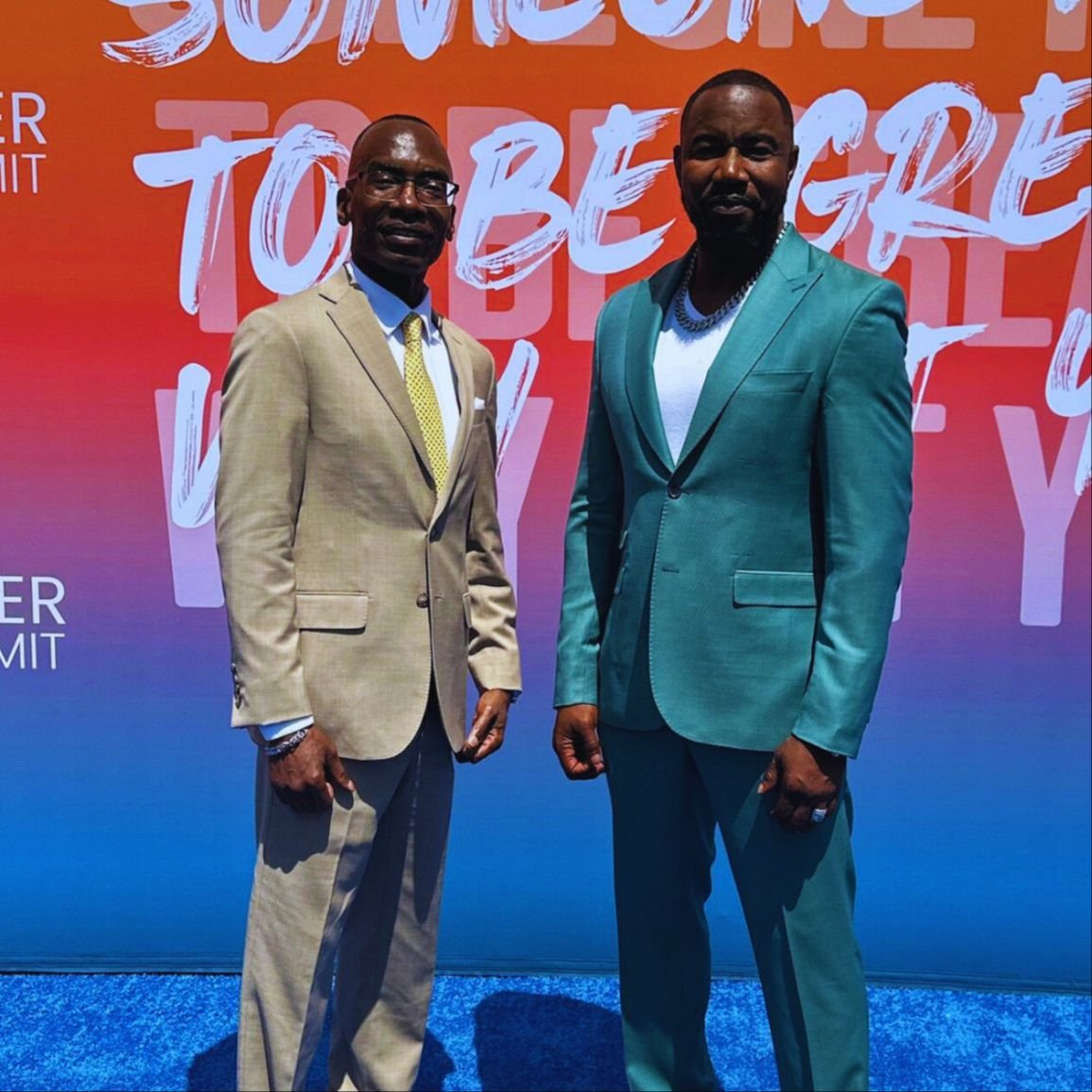 Dr. Michael Thompson standing next to a man, smiling at the camera.